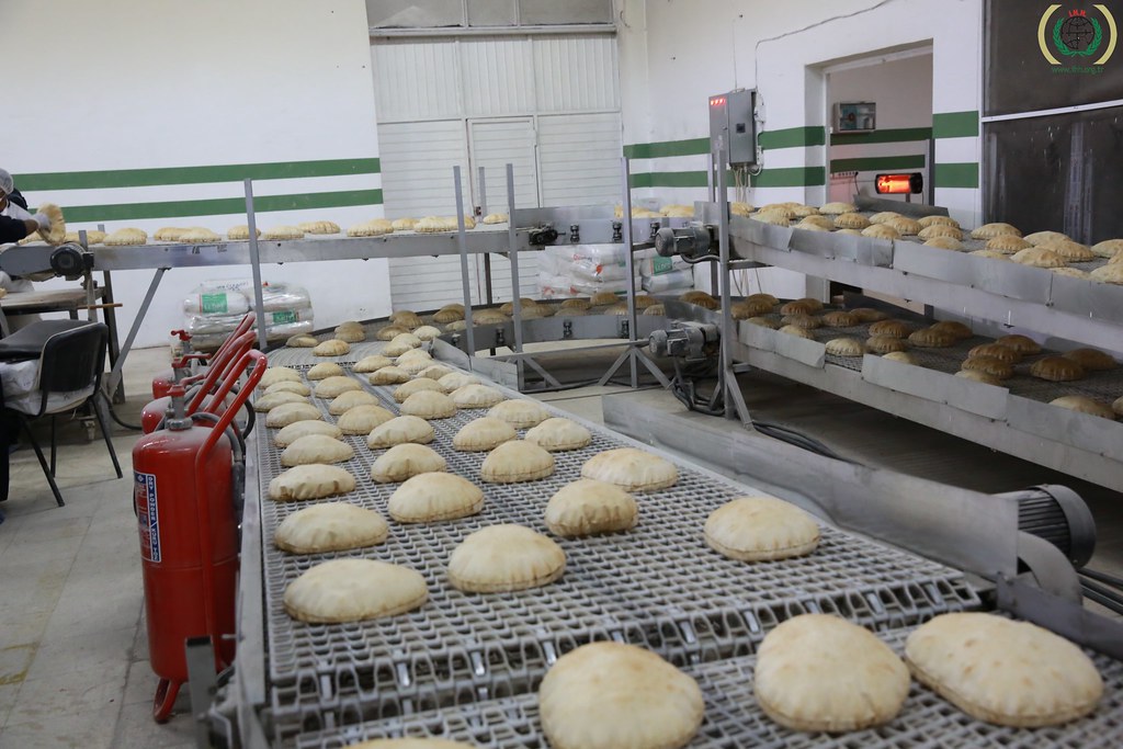 "The bakery oven established by IHH in Reyhanlı district of Hatay daily produces hundred of thousands breads for Syrian refugees" by İHH İnsani Yardım is licensed under CC BY-NC-ND 2.0.